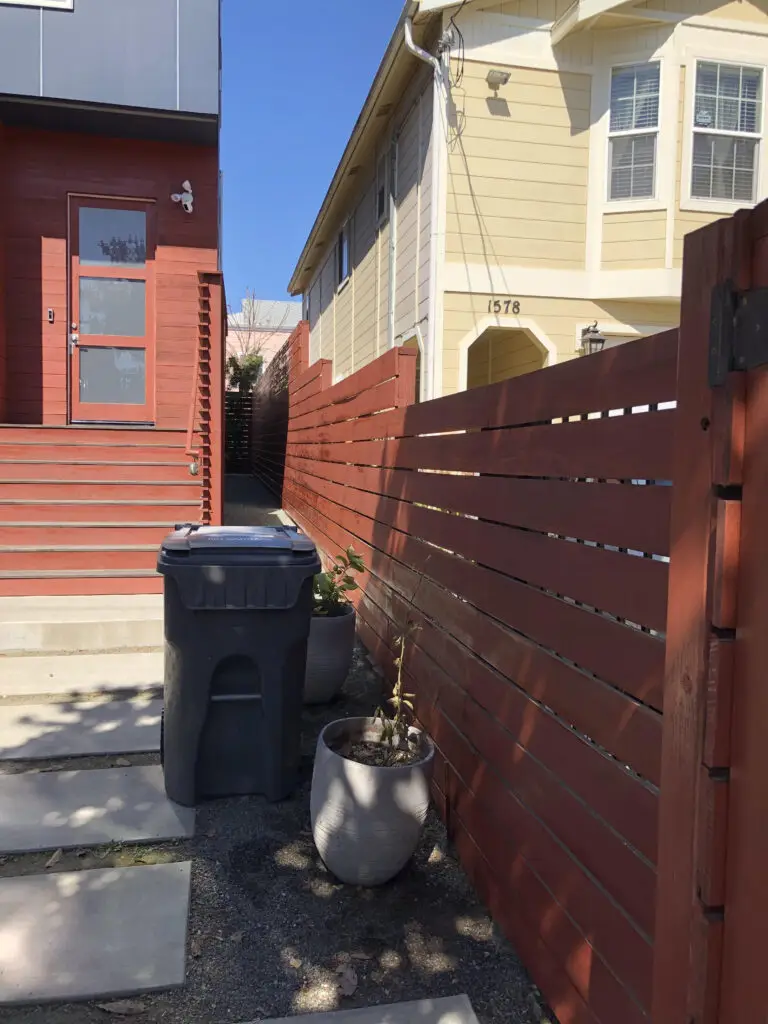 maroon privacy fence painting on side of the house